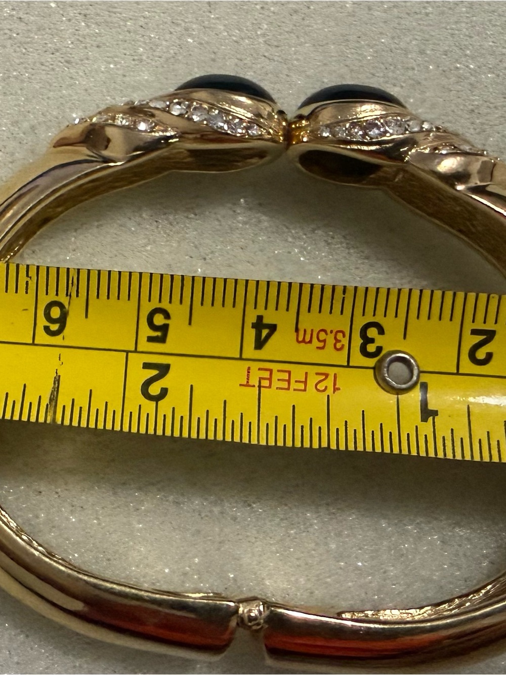 Gold-Tone Hinged Bangle Bracelet with Black Cabochon and Crystal Accents